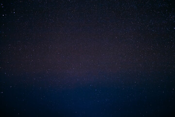 Vibrant purple and black starry night sky texture with constellations. © Great Brut Here