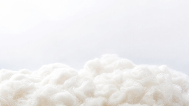 Soft white cotton fiber texture, fluffy raw cotton material background, organic textile stuffing for pillow and mattress