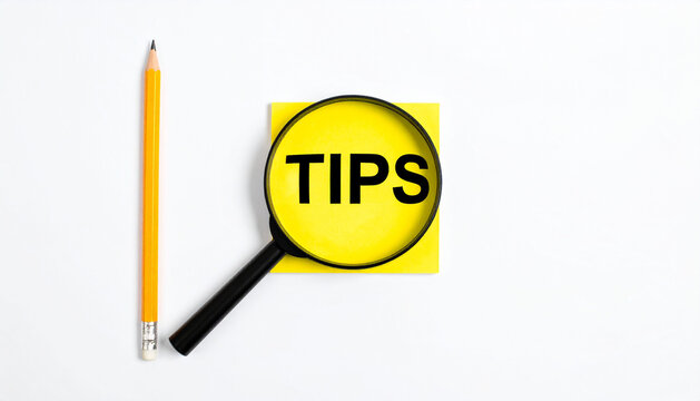 Tips and Useful Information Concept with Magnifying Glass and Sticky Note
