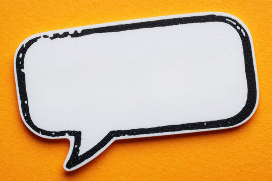 White blank speech bubble icon with black outline on bright orange background. Empty comic chat bubble for text message. Simple graphic element for communication, marketing, business presentation.