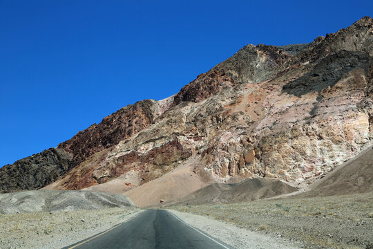 The road and pink cliffs - Death Valley National Park, California
