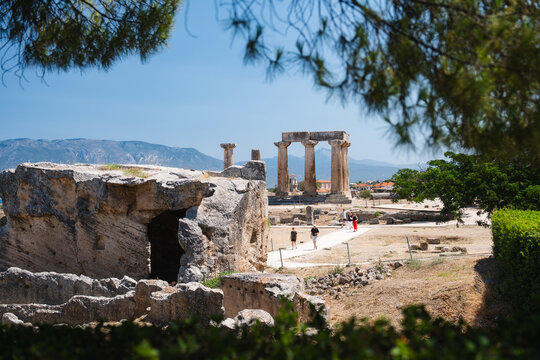 Ancient Greek temple ruins at Corinth beneath a clear blue sky