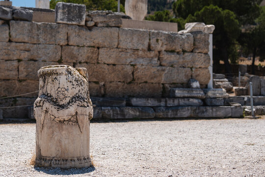 Ancient Greek temple ruins at Corinth beneath a clear blue sky