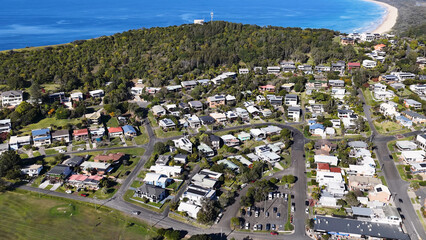 Fototapeta premium Aerial View of Suburban Houses and Green Hills in Crescent Head