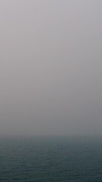 Misty Ocean Horizon at Dawn with Calm Water