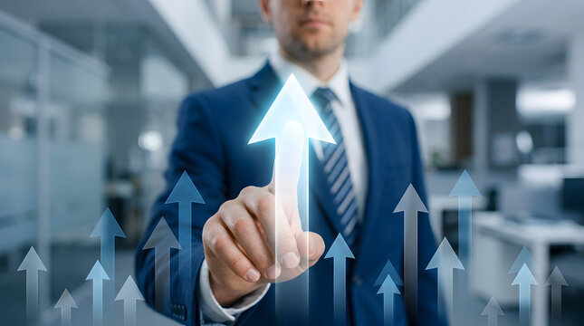 Professional businessman in a blue suit touching a glowing upward arrow on a virtual interface with multiple ascending arrows in a modern office background featuring formal wear, tie and workplace