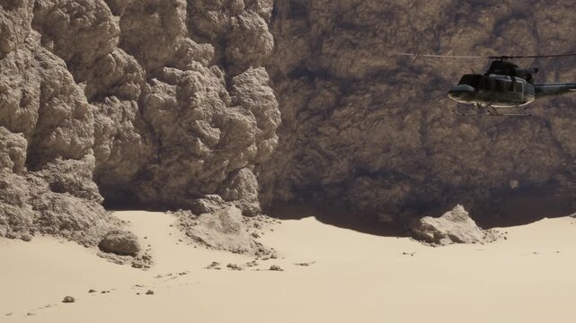 A helicopter flies above a sandy landscape with large rock formations in the background. The ground shows signs of footprints and small rocks scattered around the area.
