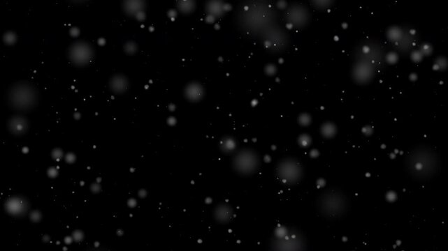 This abstract image presents falling white snow against a stark black background, perfect for winter holiday designs, overlays, and festive seasonal projects.