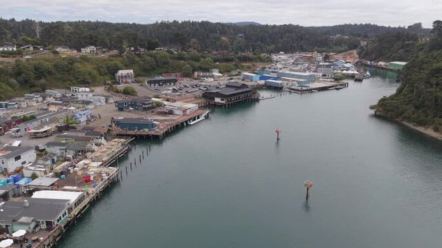 Discover the Noyo Harbor River and its seafood markets and restaurants in Fort Bragg California, showcasing waterfront activity.