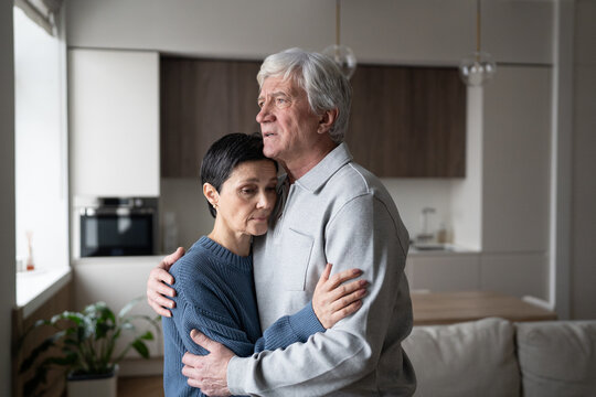Distressed pensive elder husband comforting embracing wife. Spouse support, affectionate bond, emotional resilience, mature couple connect, health struggles, enduring love, senior mental care.