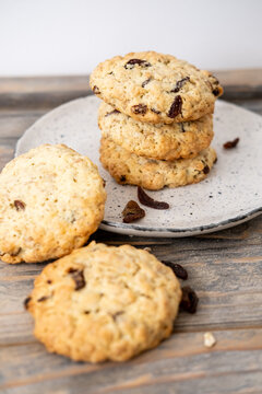 Cookies plate. Homemade pastry. Baked biscuits with raisins cereal served stack on wooden table. Healthy traditional meal background.