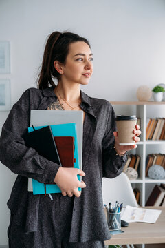 Business routine. Office lifestyle. Creative woman freelancer with laptop coffee using notebook preparing for daily occupation at modern workplace.