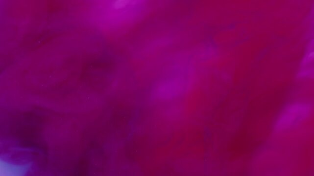 Paint drop. Fume blend. Blur blue pink purple colorful ink glitter splash vibrant texture underwater cloud on abstract background.