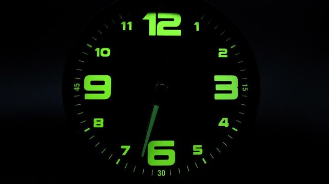 Tme lapse video of a clock time passing over a day to night on black background.