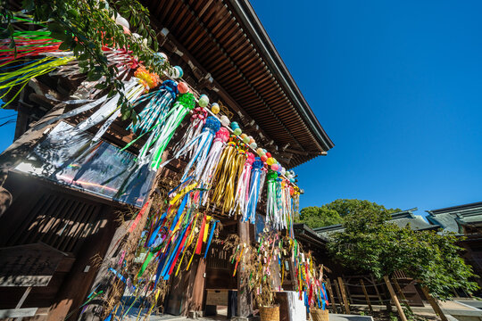 Low angle view of Miyajidake Shrine wooden gate decorated with colorful tanabata streamers in Fukutsu, Fukuoka, Japan