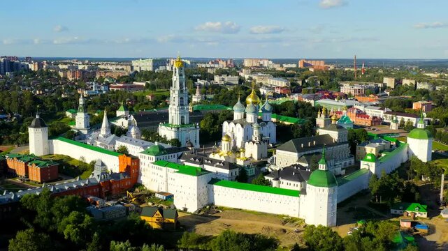 Sergiev Posad, Russia. Trinity Lavra of St. Sergius, white-walled monastery complex with golden and blue onion domes and baroque bell tower, Drone footage at sunset. Drone footage, Point of interest