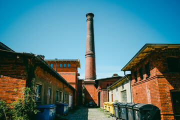 Old brick chimney in former industrial complex near Fröbelstraße, Berlin-Pankow, Germany © gadalab