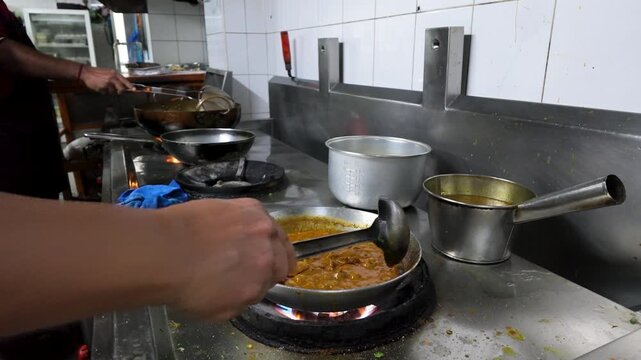 Chef Stirring Indian Curry in Commercial Kitchen in Bangkok