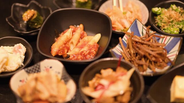 Assorted Japanese Izakaya Side Dishes and Appetizers in Ceramic Bowls