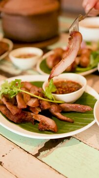 Grilled Pork Jowl with Spicy Dipping Sauce and Thai Isan Cuisine