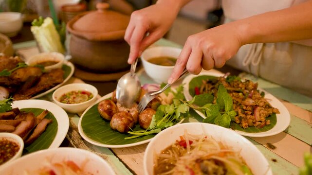 Traditional Thai Isan Street Food Spread with Fermented Sausage and Papaya Salad