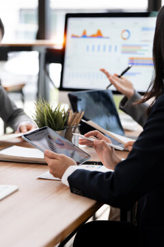 Close Up Business Professional Holding Digital Tablet and Stylus Pen with Computer Monitor Background