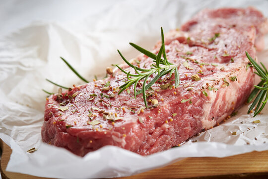 raw beef steak with herbs
