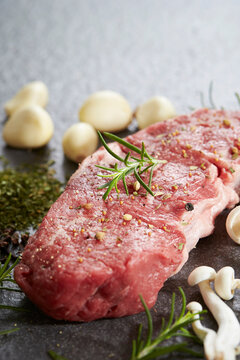 raw beef steak with herbs