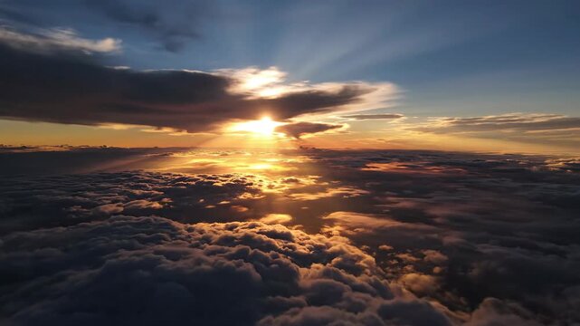Aerial view of clouds with golden sunlight rays shining through