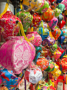 Colorful traditional Vietnamese silk lanterns hanging in market. Symbolizes cultural heritage and festive atmosphere. Ideal for travel, tourism, and cultural content