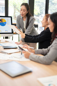 Business Meeting Asian Businesswomen Analyzing Financial Chart Document