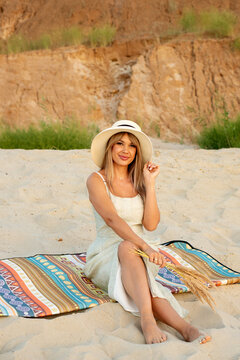Blonde Woman Posing Alone On Sandy Beach Mat