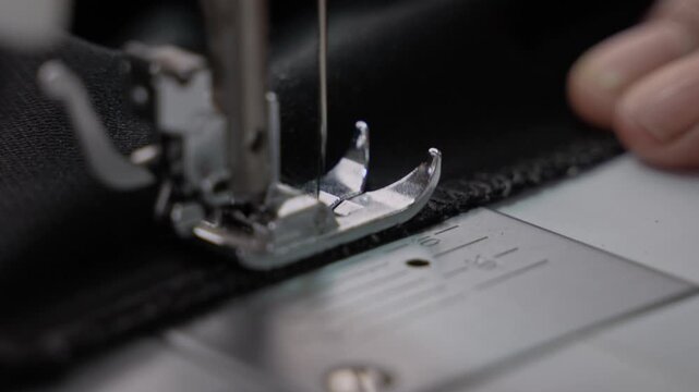 Man Stitching Clothes Using an Electric Sewing Machine