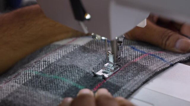 Man Stitching Clothes Using an Electric Sewing Machine