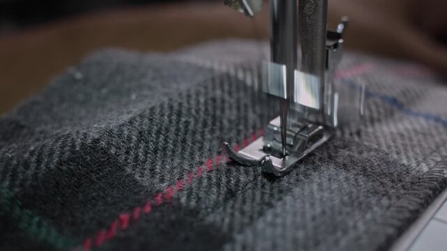Man Stitching Clothes Using an Electric Sewing Machine