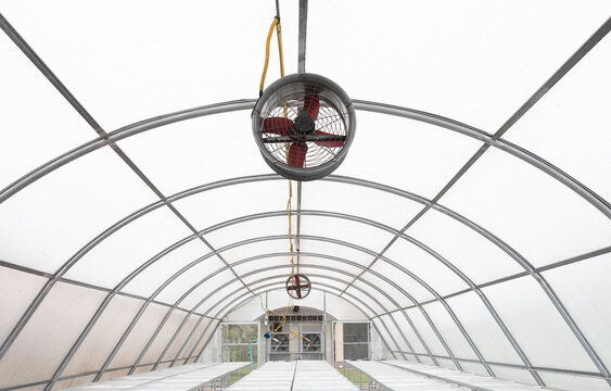Fan ventilation greenhouse ceiling structure roof solar arch steel detail exhaust blower cooling air airflow circulation interior translucent clear panel frame dome tunnel facility