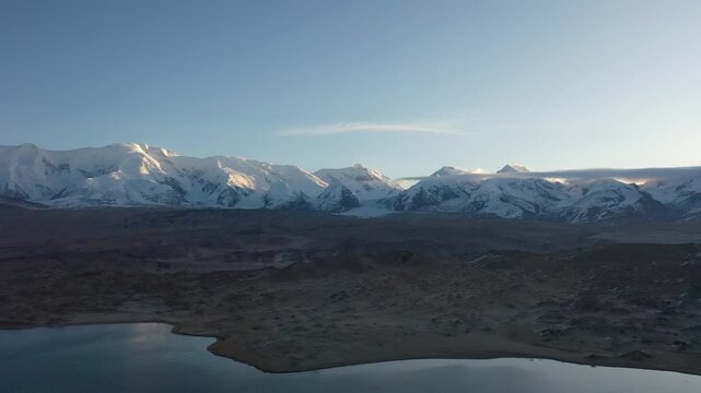 Aerial view of Kongur Tiube snow mountain and Karakul Lake in Xinjiang, China