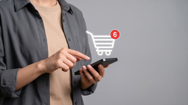 Hands using a smartphone with a digital shopping cart icon and notification badge, Online shopping, e-commerce and retail apps