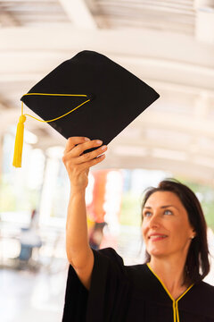 Happy young woman with diploma on graduation day