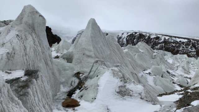 Aerial view of Muztagh Ata Glacier No. 2 in Xinjiang, China, showing majestic snow-capped mountains and ice formations.