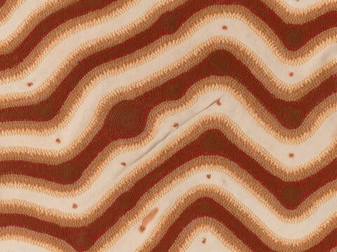 Lilac and red dot-work fabric panel with wavy meandering bands and circular motifs, featuring a textured canvas weave for textile and surface pattern design