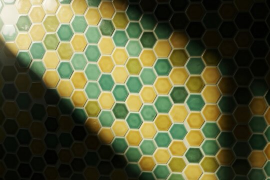 Vibrant Hexagonal Tile Pattern in Sunlit Interior, Play of Light and Shadow, Green and Yellow Color Palette, Geometric Design, Capturing Artistic Architectural Detail