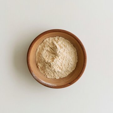 Wooden bowl of chickpea flour on a cream background, featuring a soft matte texture and natural grain for baking ingredients and food packaging