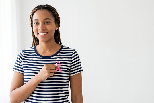 Young woman with box braids pink ribbon wearing striped shirt