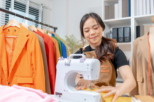Professional fashion designer measuring fabric, selecting colors and preparing sewing equipment in a modern studio. Creative garment production, textile craftsmanship and apparel design.