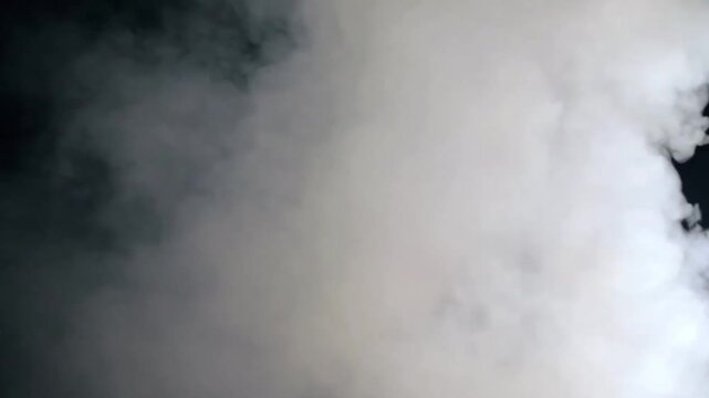 White smoke or fog rolling and billowing isolated on a black background