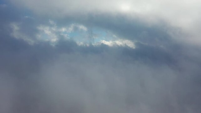 dramatic clouds with sun rays breaking through the dark sky