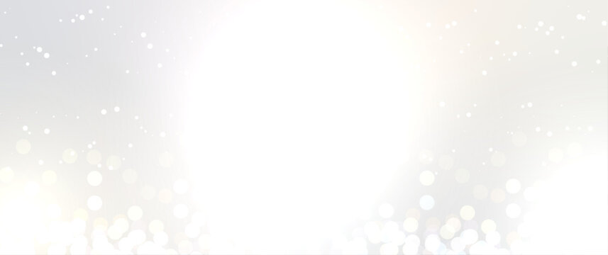 Bright white silver christmas background with bokeh light particles and copy space