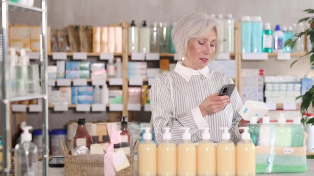 Pensioner pays for purchases at the pharmacy using a QR code and contactless payment methods 