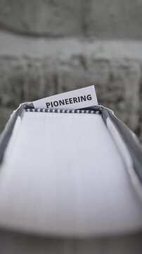 Pioneering Word on White Paper Symbolizing Innovation and Progress